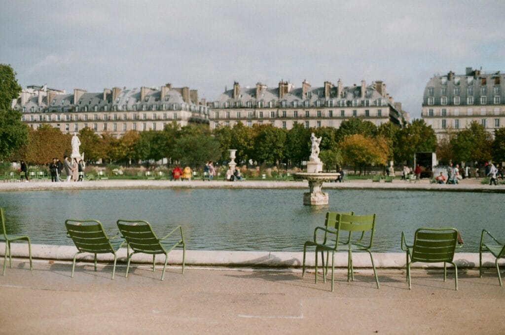 Green chairs beside fountain in Tuileries Garden in Paris France